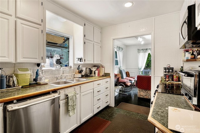 kitchen featuring white cabinetry, appliances with stainless steel finishes, and a sink