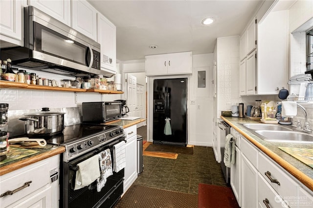 kitchen featuring a toaster, backsplash, white cabinetry, a sink, and black appliances