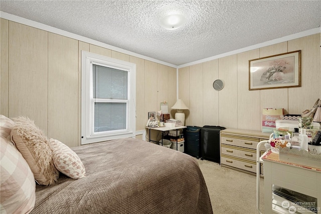 bedroom with ornamental molding, light colored carpet, and a textured ceiling