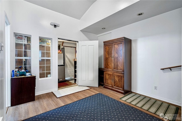 interior space featuring baseboards and wood finished floors