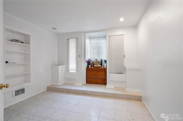 foyer entrance with visible vents, baseboards, and recessed lighting