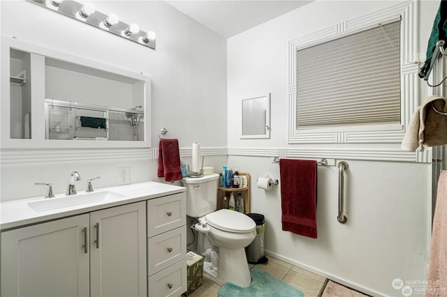 full bathroom featuring toilet, a shower stall, vanity, and tile patterned floors