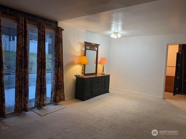 bedroom with baseboards, carpet floors, access to exterior, and crown molding