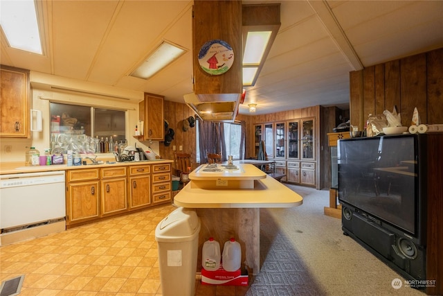 225 Magnus Rd, Onalaska, WA 98570 - kitchen with white dishwasher, wooden walls, brown cabinetry, and light countertops
