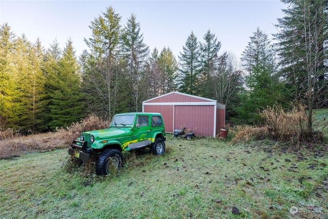 225 Magnus Rd, Onalaska, WA 98570 - view of yard featuring an outbuilding, an outdoor structure, a garage, and a view of trees