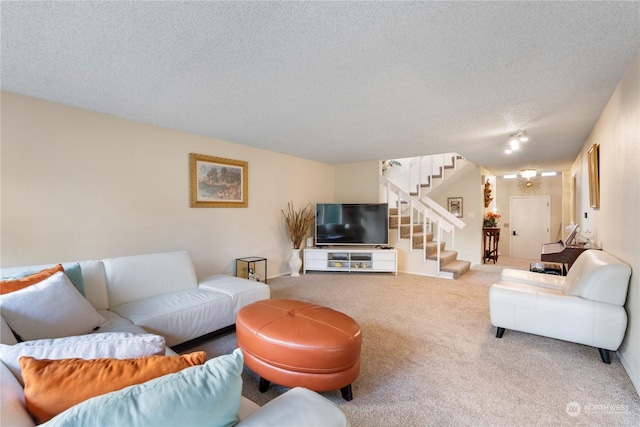 carpeted living room featuring a textured ceiling