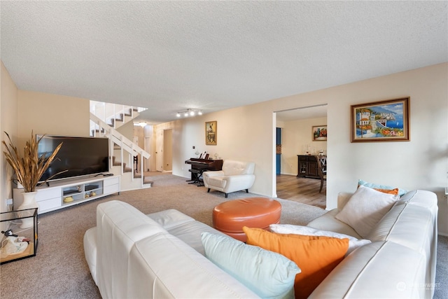 carpeted living room with a textured ceiling