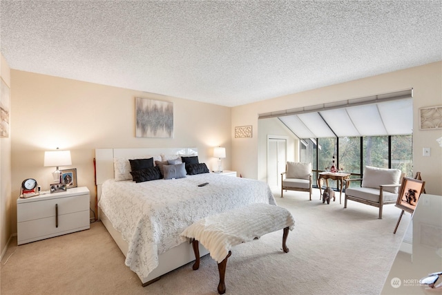 carpeted bedroom with a textured ceiling and lofted ceiling