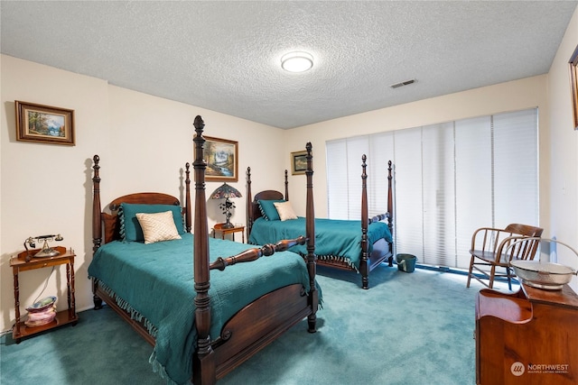 carpeted bedroom featuring a textured ceiling