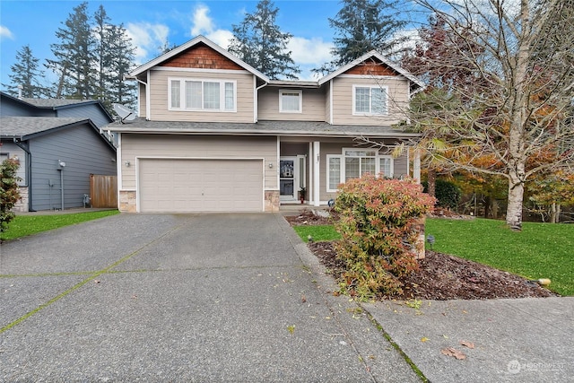 craftsman inspired home featuring a front yard and a garage