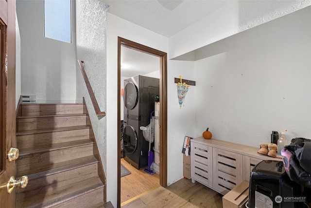 17305 Stone Ct N, Shoreline, WA 98133 - interior space with stacked washer / drying machine and wood finished floors