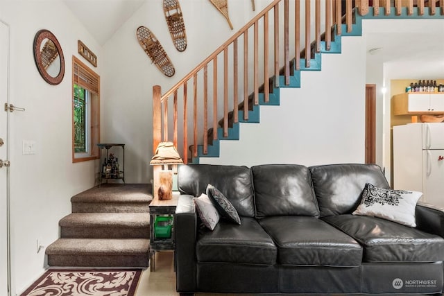 living room featuring lofted ceiling