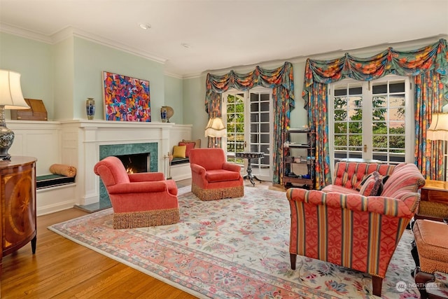 living room featuring french doors, a premium fireplace, hardwood / wood-style floors, and plenty of natural light