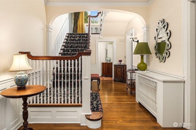 hall with dark hardwood / wood-style flooring and ornamental molding