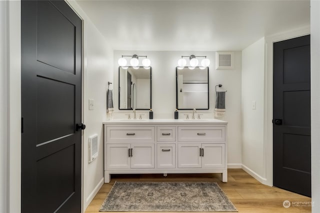 bathroom featuring vanity and wood-type flooring