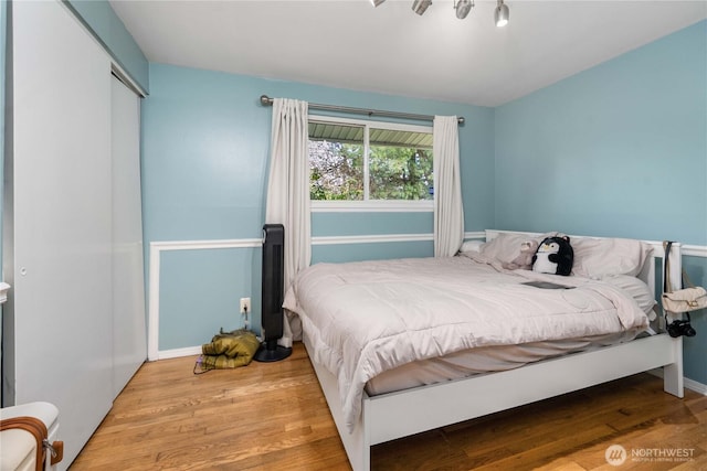 bedroom with a closet and wood finished floors