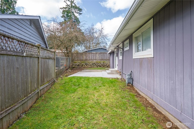 view of yard with a patio area and a fenced backyard