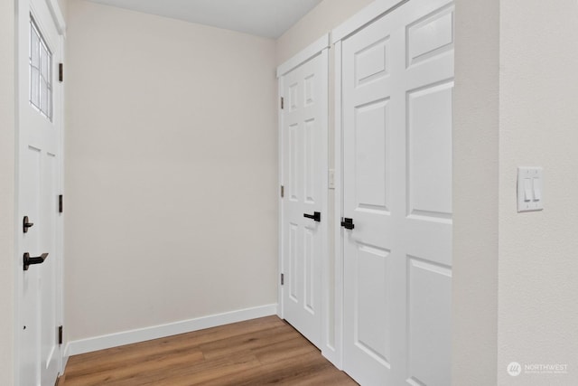 corridor with hardwood / wood-style floors