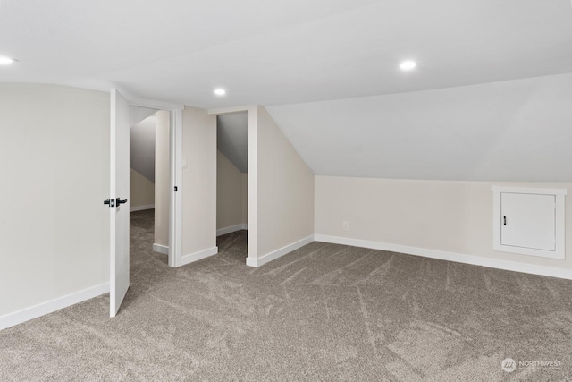 bonus room with carpet flooring and lofted ceiling