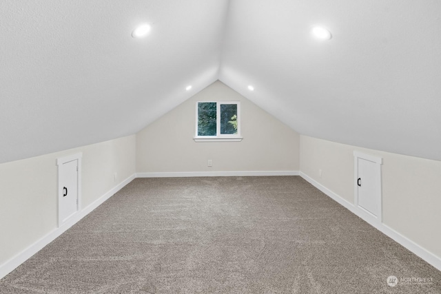 bonus room featuring lofted ceiling and carpet floors