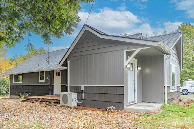 back of house with ac unit and a wooden deck