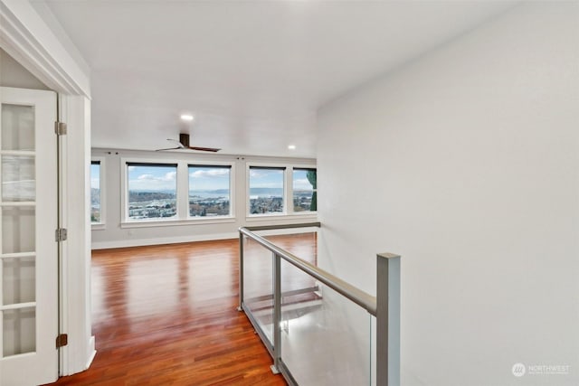 hallway with hardwood / wood-style flooring