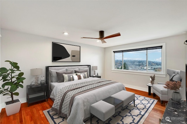 bedroom with hardwood / wood-style flooring and ceiling fan