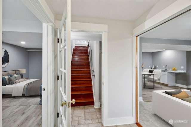 staircase with hardwood / wood-style floors