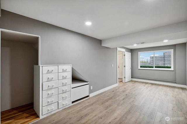 spare room with light hardwood / wood-style flooring