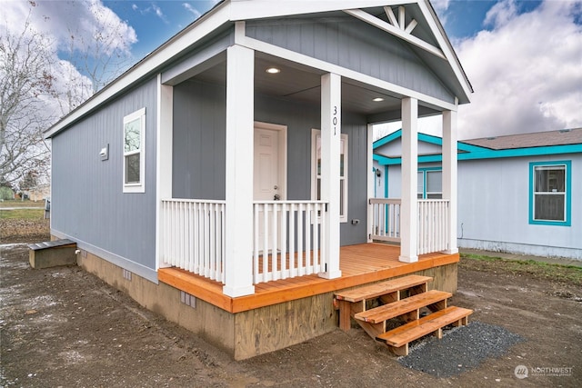 property entrance with covered porch