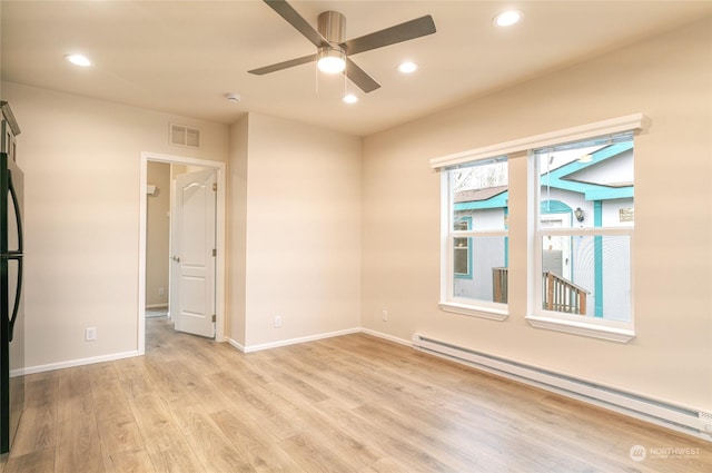 unfurnished room featuring ceiling fan, light hardwood / wood-style flooring, and a baseboard radiator