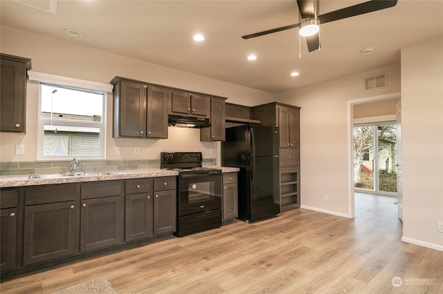 kitchen featuring dark brown cabinetry and black appliances