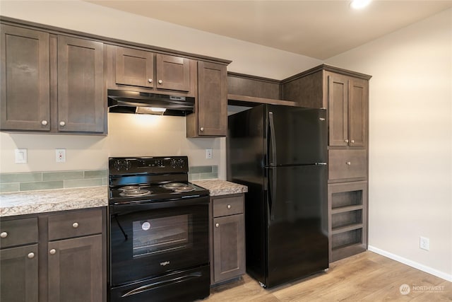 kitchen featuring dark brown cabinetry, light hardwood / wood-style floors, and black appliances