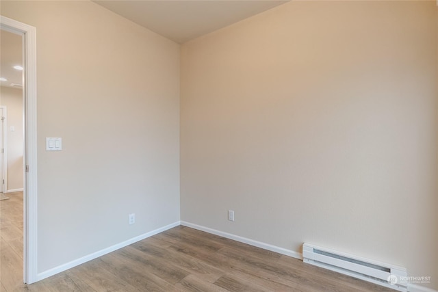 spare room with light hardwood / wood-style floors and a baseboard radiator