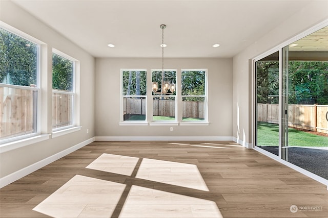 unfurnished sunroom with a chandelier