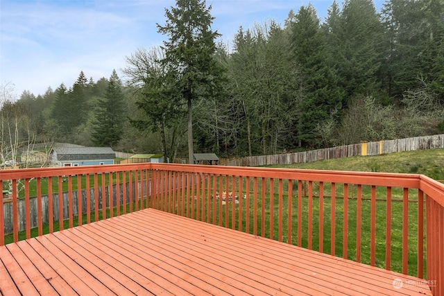 deck featuring a lawn and an outbuilding