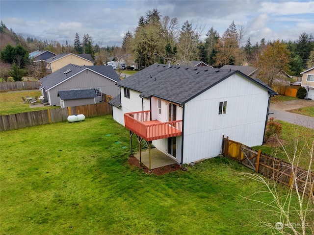 back of property with a deck and a lawn