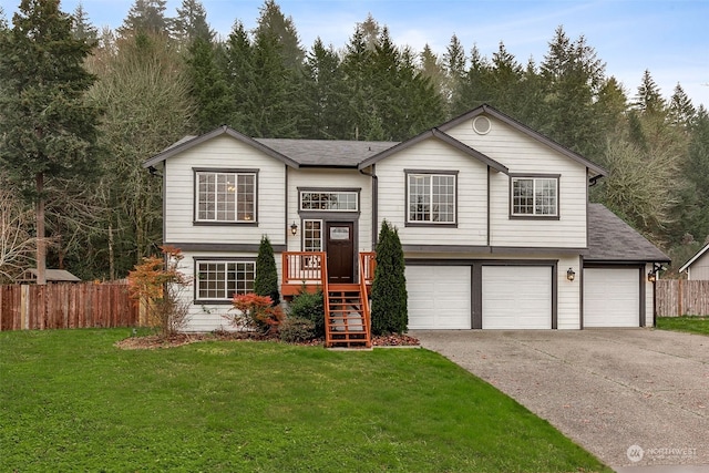 raised ranch with a front yard and a garage