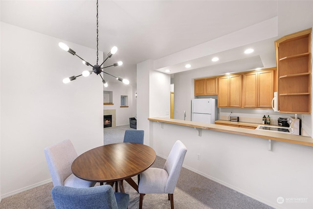 dining area featuring light carpet and a notable chandelier