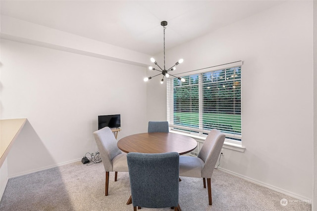 dining room with carpet flooring and an inviting chandelier