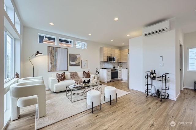 living room with light wood-type flooring and a wall unit AC