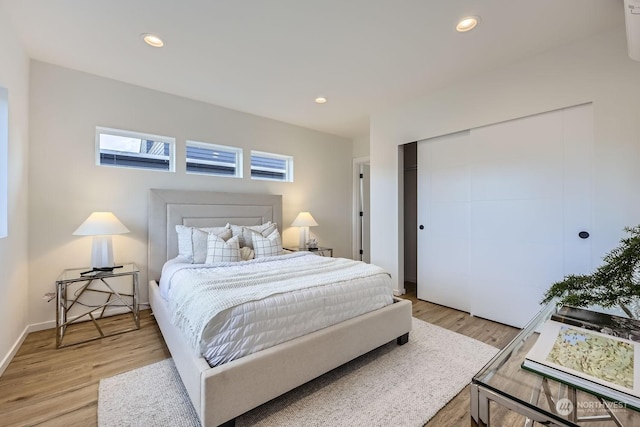 bedroom featuring a closet and light wood-type flooring