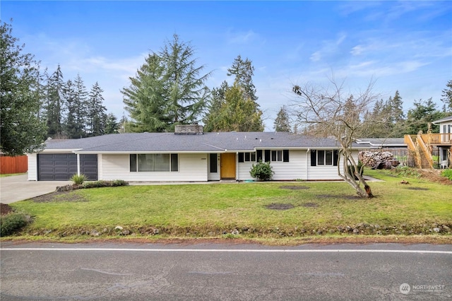 single story home featuring a garage and a front lawn