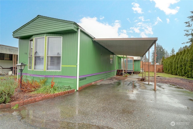 view of side of property with a carport