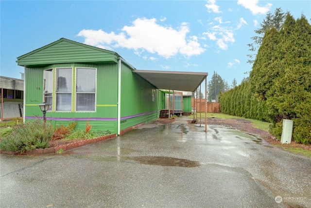 view of side of home featuring a carport