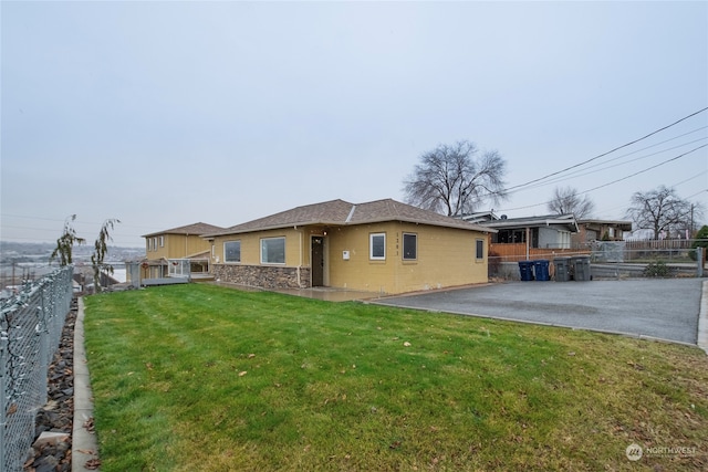 back of house featuring a patio area and a yard