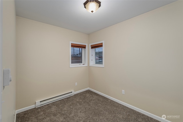 carpeted spare room featuring a baseboard heating unit