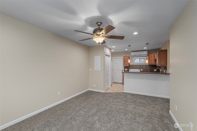 unfurnished living room with light carpet, sink, and ceiling fan