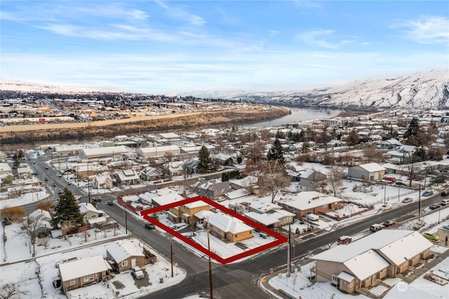 snowy aerial view with a mountain view