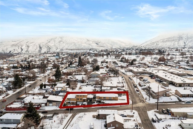 snowy aerial view with a mountain view